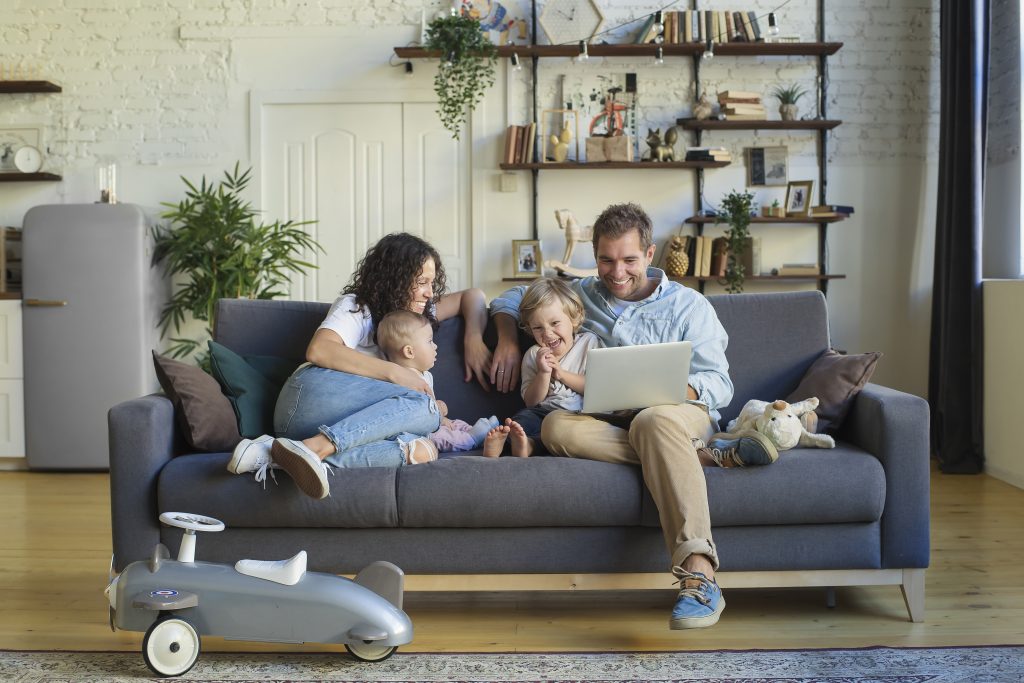 Young beautiful happy family relaxing at home - Kingdom Resources